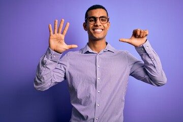 Naklejka premium Handsome african american man wearing striped shirt and glasses over purple background showing and pointing up with fingers number six while smiling confident and happy.