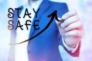 Writing note showing Stay Safe. Business concept for secure from threat of danger, harm or place to...