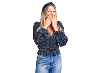 Young beautiful blonde woman wearing casual clothes laughing and embarrassed giggle covering mouth...