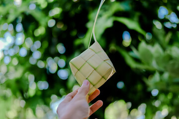 Ketupat or rice dumpling is a local delicacy during the festive season on natural background.