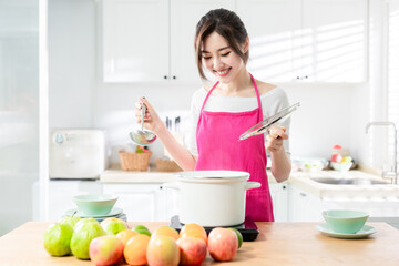 Obraz na płótnie Canvas Asian housewife cook healthy meal