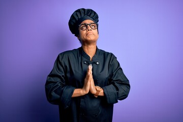 Young african american chef girl wearing cooker uniform and hat over purple background begging and praying with hands together with hope expression on face very emotional and worried. Begging.