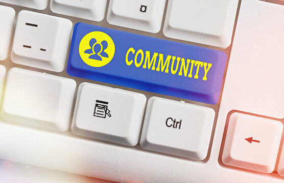 Text sign showing Community. Business photo text group of showing with a common characteristics living together White pc keyboard with empty note paper above white key copy space
