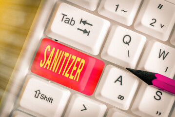 Writing note showing Sanitizer. Business concept for liquid or gel generally used to decrease...