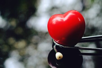 red heart and stethoscope on table