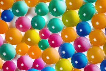 Fototapeta na wymiar Sweet jelly balls background pattern. Dessert balls scattered on the table. Colorful backdrop with transparent candy