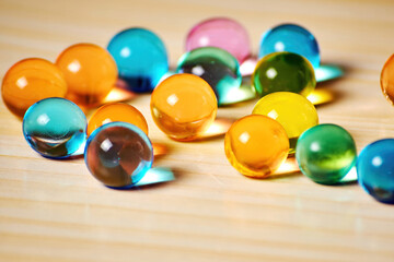 Jelly balls are scattered on the table like bright pearls. Vivid dessert candies. Food and drink backdrops