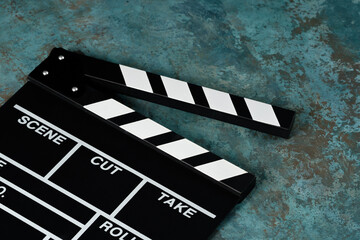 Clapper board with popcorn. Movie concept. Clapperboard on a textural background. Close-up. Copy...