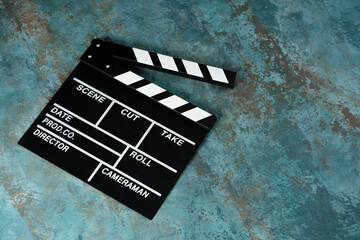 Clapper board with popcorn. Movie concept. Clapperboard on a textural background. Close-up. Copy...