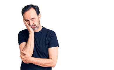 Middle age handsome man wearing casual t-shirt thinking looking tired and bored with depression problems with crossed arms.