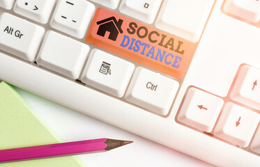 Writing note showing Social Distance. Business concept for maintaining a high interval physical...