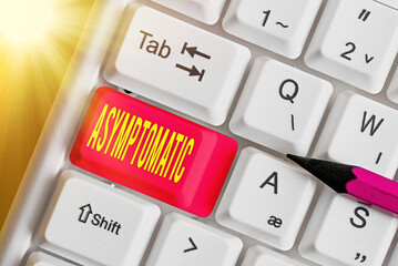 Writing note showing Asymptomatic. Business concept for a condition or an individual producing or...