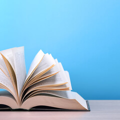 The book is open, lying on the table, sheets fanned out on a blue background.