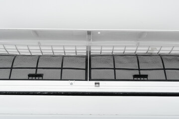 The guy cleans the filter of the home air conditioner from dust. Very dirty air conditioner filter....