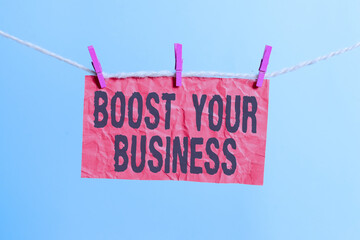 Handwriting text writing Boost Your Business. Conceptual photo Suitable for web Landing page, web page design to increase profit Clothesline clothespin rectangle shaped paper reminder white wood desk