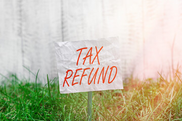 Conceptual hand writing showing Tax Refund. Concept meaning excess payment of paid taxes returned...