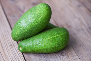 Fresh green avocado on the wooden table - Fruits healthy food concept