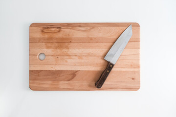 Knife on cutting board isolated on white kitchen background