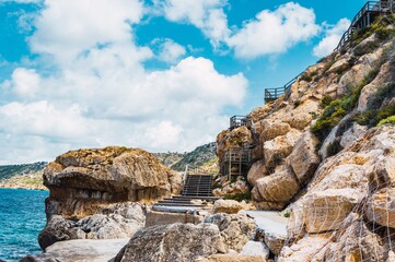 Staircase in the rocky mountains covered by a protective net