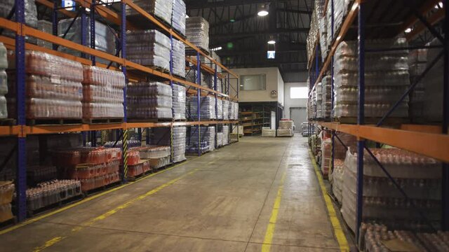 Interior Of Modern warehouse with Rows of shelves with boxes, dolly in.