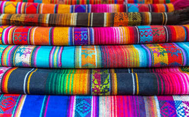 Traditional andean fabrics sold on the handicrafts market of Otavalo, Ecuador. 