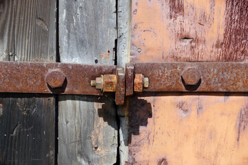 Part of an old iron door with steel straps and rivets