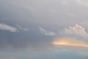 Background of a sky of grey soft color with white and pink clouds.