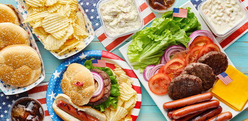 4th of july feast with burgers and hot dogs on picnic table - Powered by Adobe