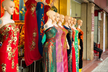 Vietnamese traditional dress Ao dai displayed in front of the cloths shop in Hanoi, Vietnam