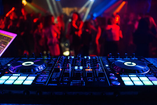 music controller DJ mixer in a nightclub at a party