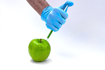 Syringe injection into a apple with sorbic acid waiting for long-term storage of fruit. Genetic...