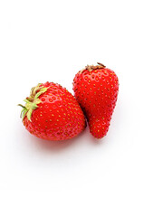 Two strawberries close up on white background