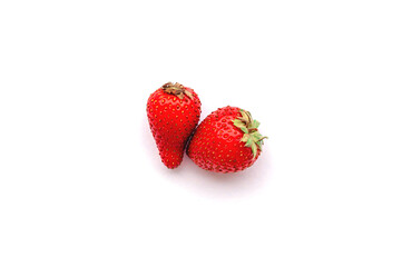 Two strawberries close up on white background