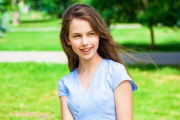 Portrait of a young beautiful teenager girl in blue dress