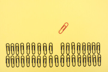 Think creatively against the system. Be different concept. Groups of folded paper clips with...