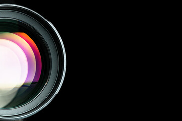 .The camera lens. Close-up of the camera lens on an isolated black background. Optics.