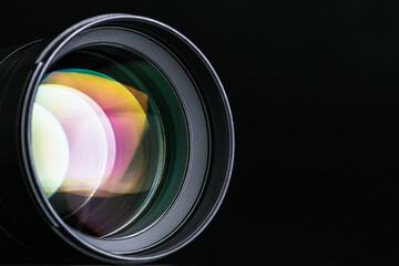 The camera lens. Close-up of the camera lens on a black background. Optics.