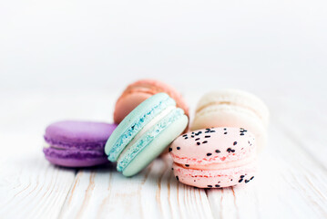 Obraz na płótnie Canvas Close up view of tasty bright colored macaroon isolated on a white background. Sweet and colorful French macaroons. Dessert. Homemade sweets. Café dessert. Selective focus