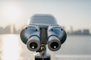 telescope with city skyline