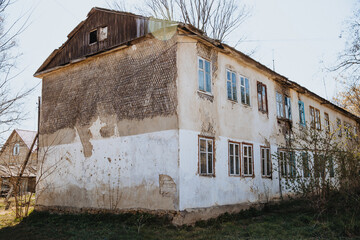 Old dilapidated, weather-beaten house that needs to be renovated. Housing problem.