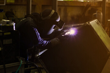 Metal workers use manual labor. Skilled welder. Factory workers making OT. Welder is welding the...