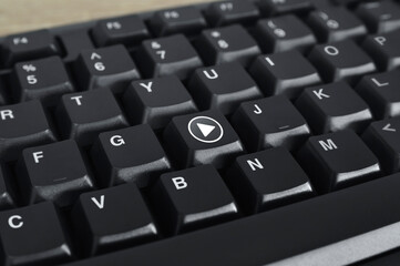Play button flat icon on black computer keyboard button, Business music online concept