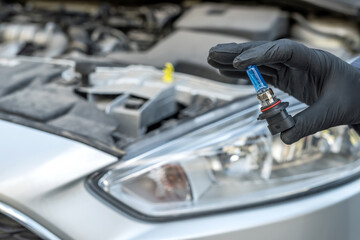 Installing replacement new modern halogen led car headlight bulb