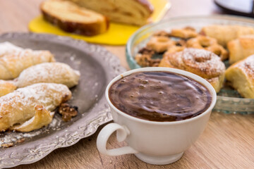 delicious homemade cakes sprinkled icing with coffee on the table for breakfast