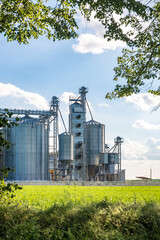 silver silos on agro-processing and manufacturing plant for processing drying cleaning and storage of agricultural products, flour, cereals and grain. Granary elevator. © hiv360