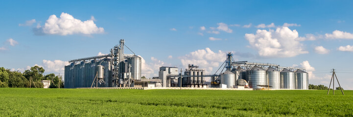 silver silos on agro-processing and manufacturing plant for processing drying cleaning and storage...