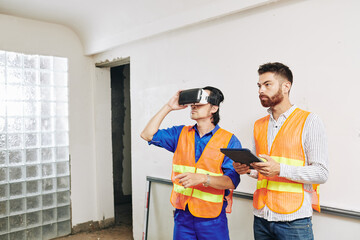 Contractor and builder using application for virtual reality headset to check wiring and pipes in...