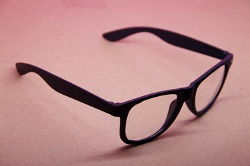 black eye glasses isolated on pink background