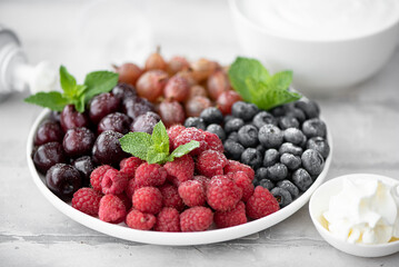 mix of fresh summer berries with yogurt and whipped cream
