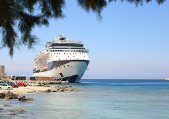 Fototapeta na wymiar large tourist cruise liner moored seaport sunny